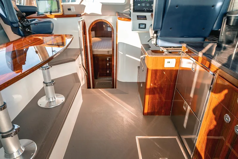 Slide: The Image of Luxurious interior of a 2019 Lindell 46' yacht with polished wood finishes. - 10
