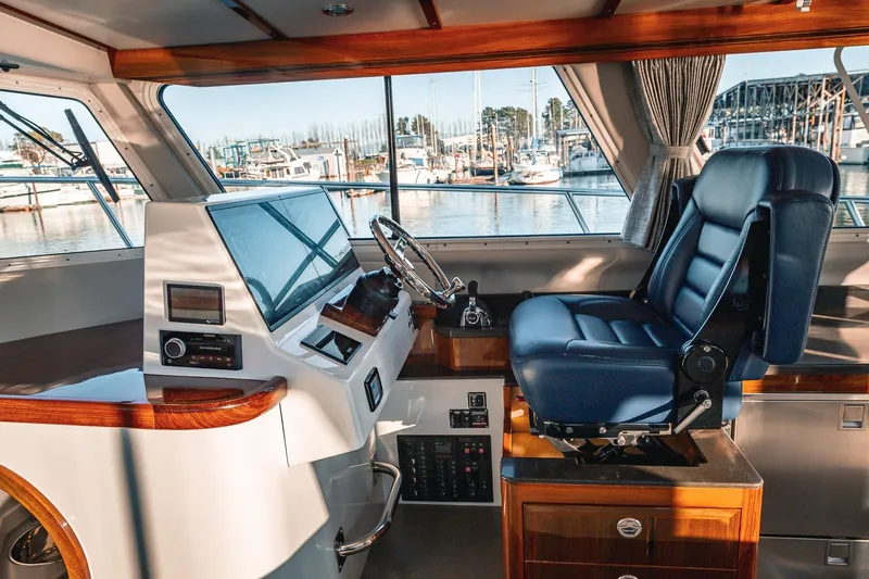 Slide: The Image of Luxurious 2019 Lindell 46' yacht helm with leather captain's chair and modern controls. - 13