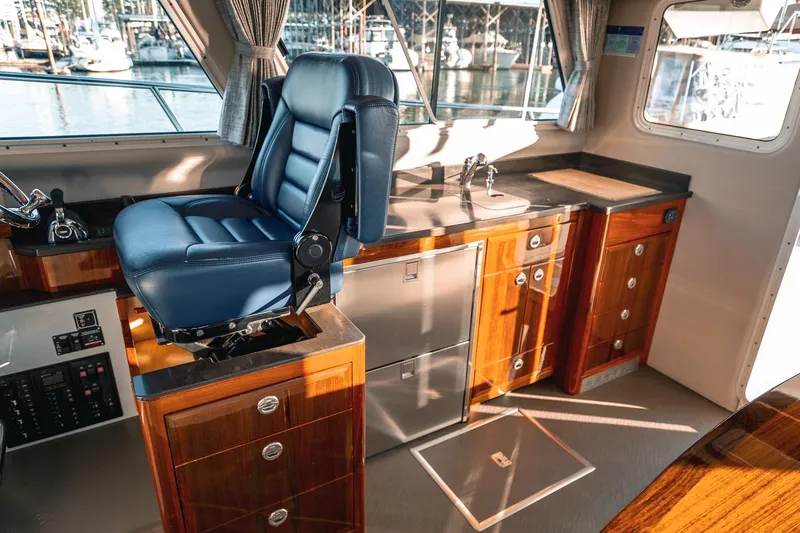 Slide: The Image of Interior of 2019 Lindell 46' yacht with helm seat and wooden cabinetry. - 14