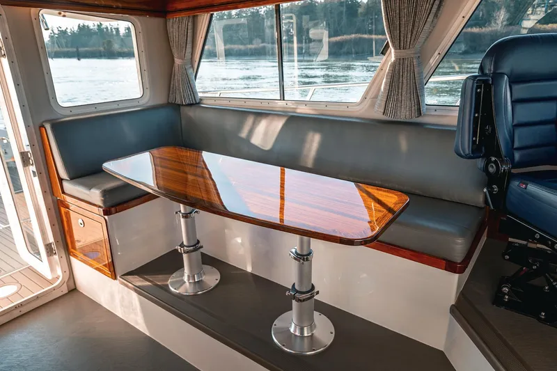 Slide: The Image of Luxurious interior of 2019 Lindell 46' yacht with polished wood table and seating. - 15