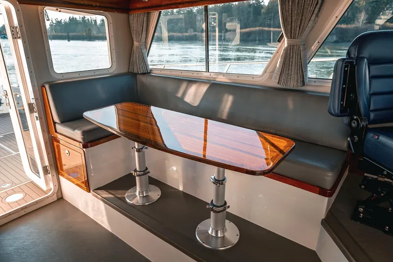 Slide: The Image of Interior of 2019 Lindell 46' yacht with polished wood table and seating area. - 16