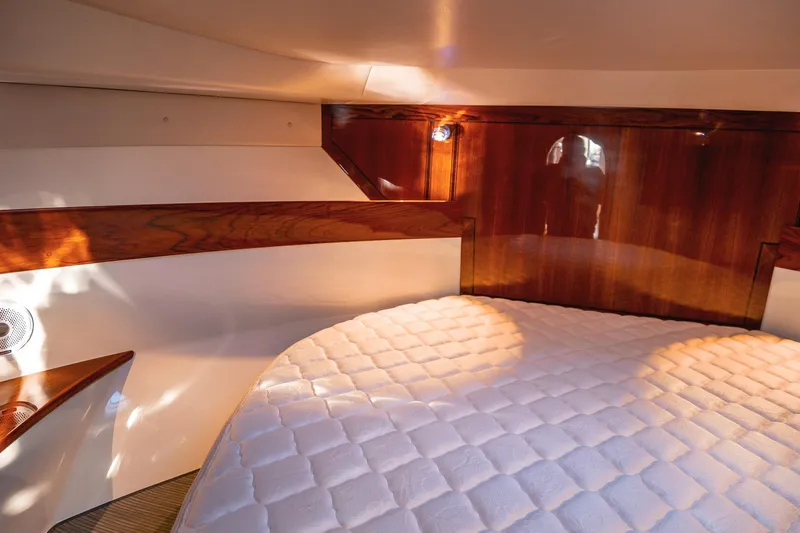 Slide: The Image of Luxurious cabin interior of 2019 Lindell 46' yacht with plush bedding and wooden accents. - 22