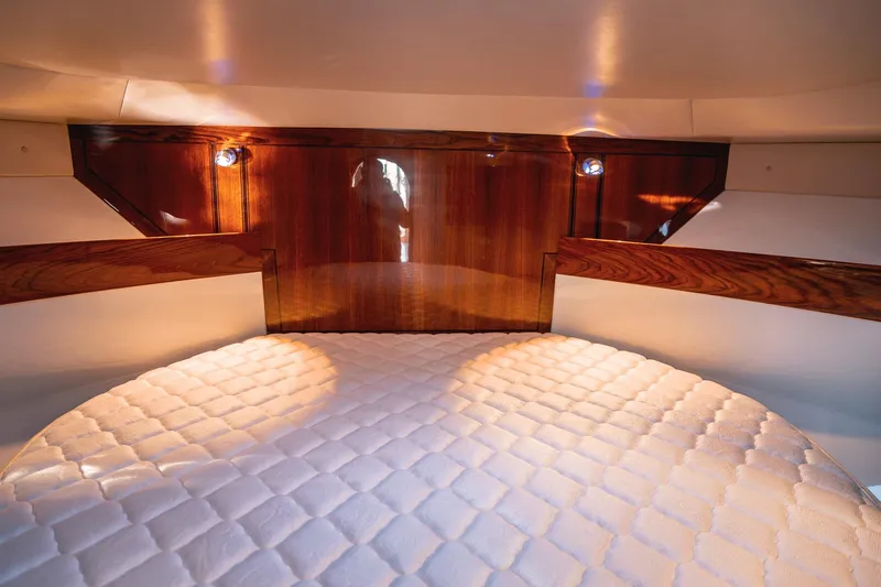 Slide: The Image of Luxurious cabin interior of 2019 Lindell 46' yacht with elegant wood finish and cozy bedding. - 23
