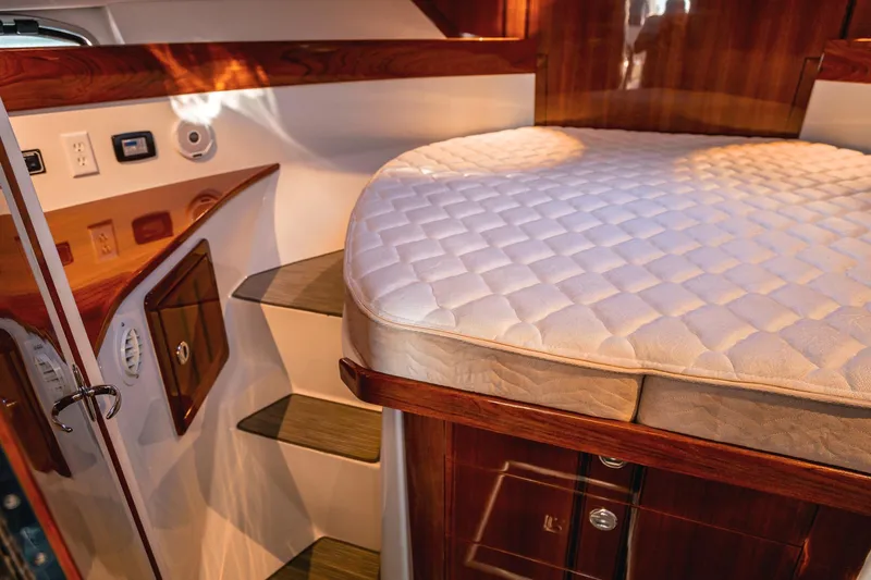 Slide: The Image of Luxurious cabin interior of a 2019 Lindell 46' yacht with wooden finishes and a cozy bed. - 24