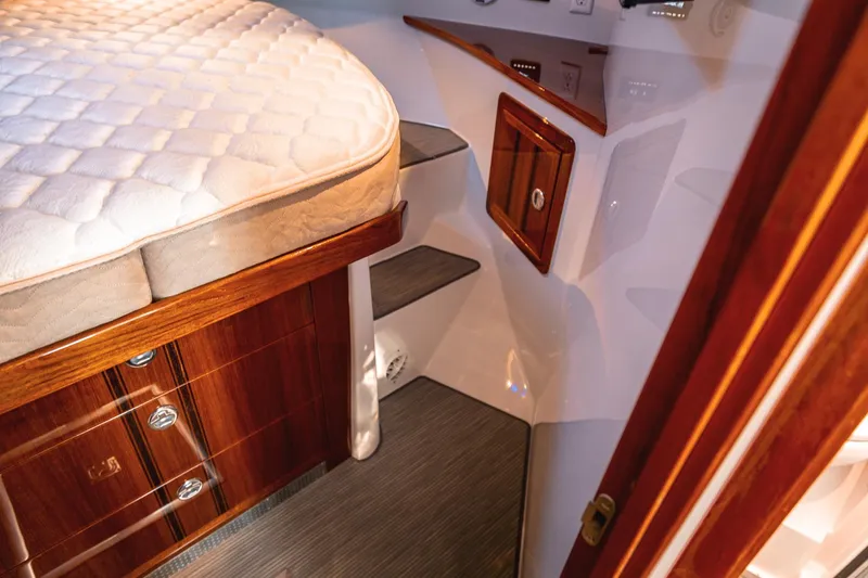 Slide: The Image of Luxurious interior of 2019 Lindell 46' yacht with wooden cabinetry and plush bedding. - 26