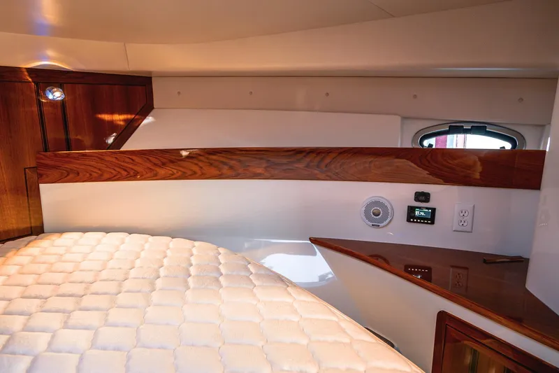 Slide: The Image of Luxurious cabin interior of 2019 Lindell 46' yacht with wood accents and plush bedding. - 28