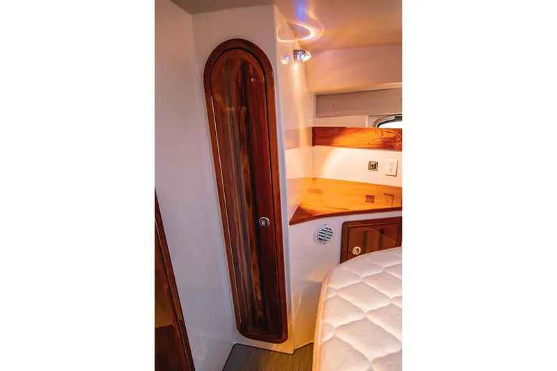 Slide: The Image of Luxurious interior of 2019 Lindell 46' yacht featuring elegant wood cabinetry and cozy sleeping area. - 33