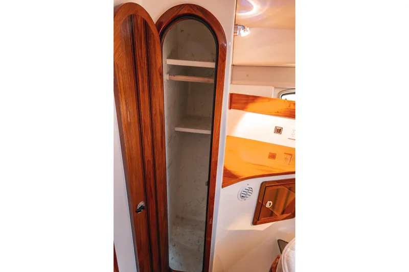 Slide: The Image of Wooden cabinet interior on a 2019 Lindell 46' boat, featuring shelves and elegant design. - 34