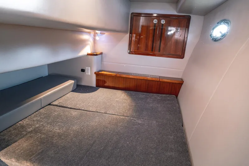 Slide: The Image of Cozy cabin interior of 2019 Lindell 46' yacht with wooden cabinetry and soft lighting. - 40