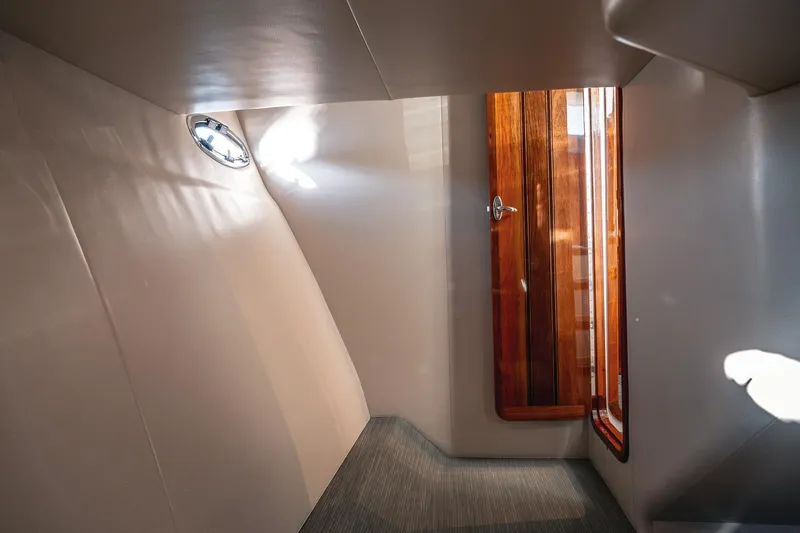 Slide: The Image of Interior of 2019 Lindell 46' yacht with wooden door and porthole window. - 43