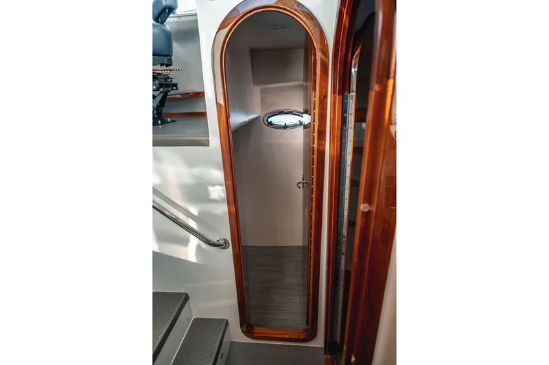 Slide: The Image of Interior view of a 2019 Lindell 46' yacht with wooden door and porthole. - 44