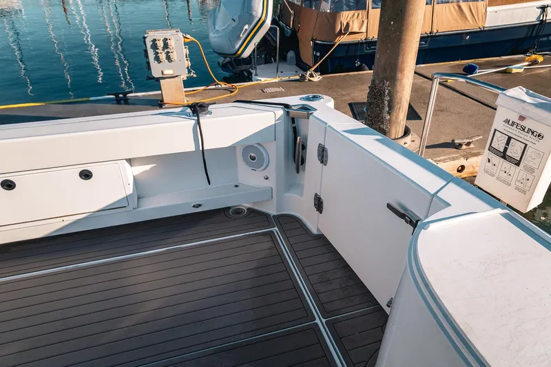 Slide: The Image of 2019 Lindell 46' boat deck with sleek design and modern fittings at a marina. - 46