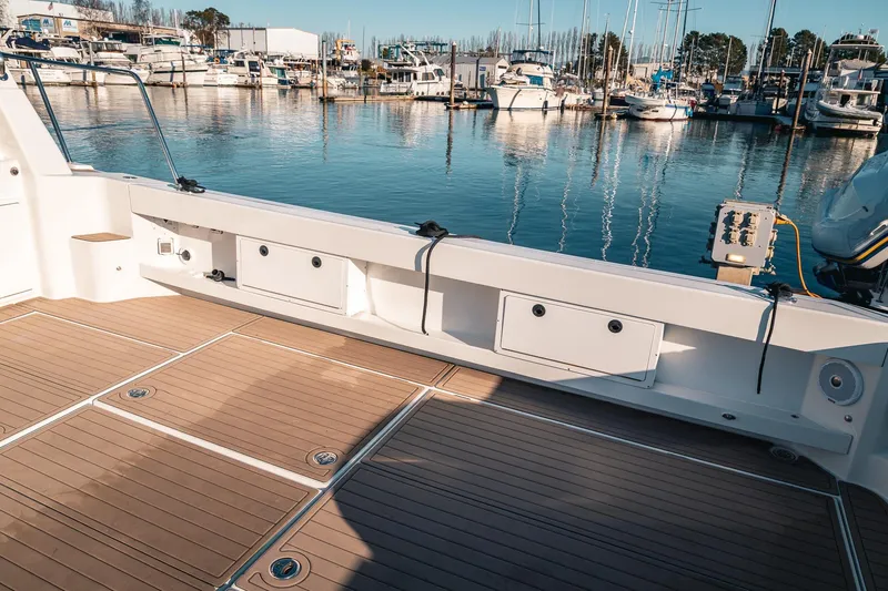 Slide: The Image of Spacious deck of a 2019 Lindell 46' yacht docked at a marina. - 49