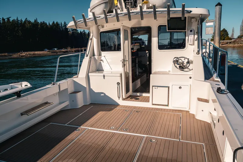 Slide: The Image of 2019 Lindell 46' boat with spacious deck and modern interior, docked by scenic waters. - 50