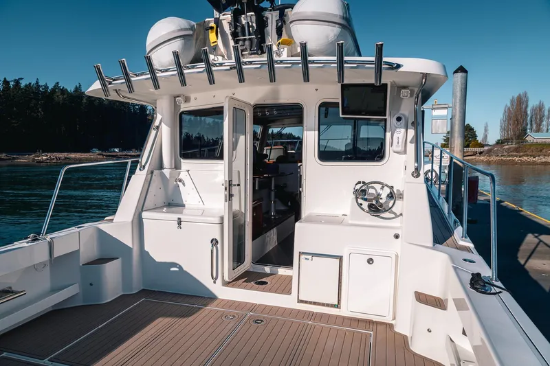 Slide: The Image of 2019 Lindell 46' boat docked, showcasing open cabin and deck area. - 51