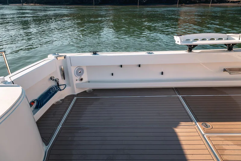 Slide: The Image of Spacious deck of 2019 Lindell 46' boat with water view and fishing rod holders. - 55
