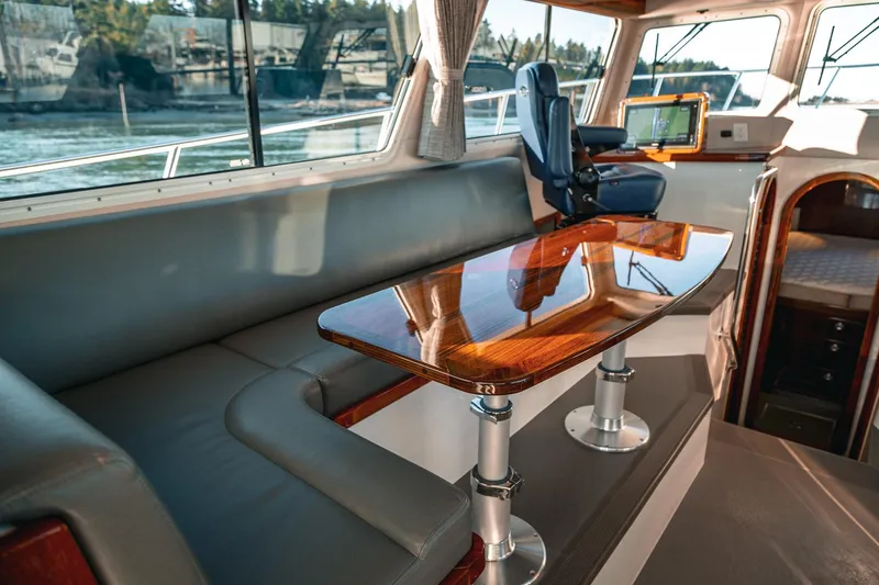 Slide: The Image of Interior of 2019 Lindell 46' yacht with polished wood table and seating area. - 6
