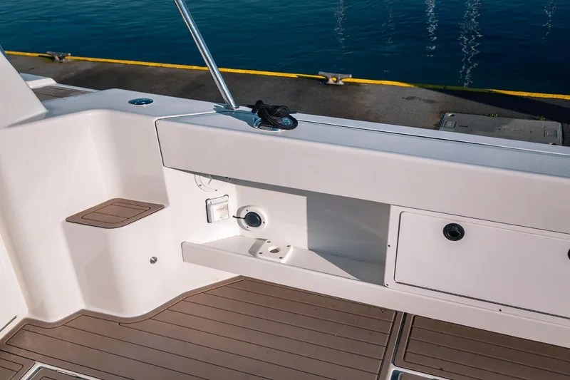 Slide: The Image of 2019 Lindell 46' boat deck with storage compartments and water view. - 60