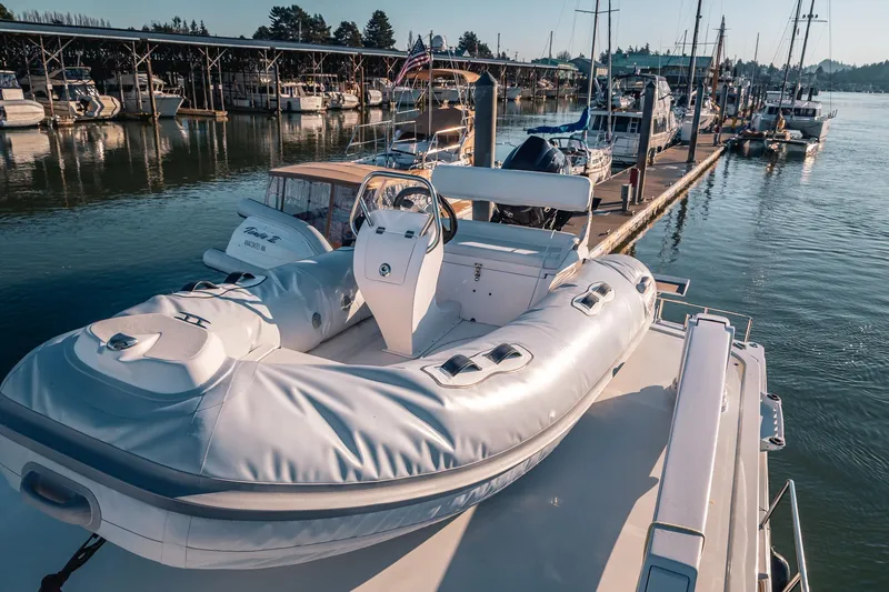 Slide: The Image of A 2019 Lindell 46' yacht docked with an inflatable boat on deck. - 66