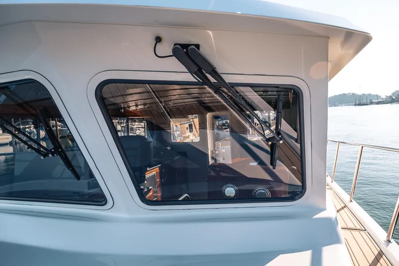 Slide: The Image of 2019 Lindell 46' yacht with sleek windows and modern design on calm waters. - 68