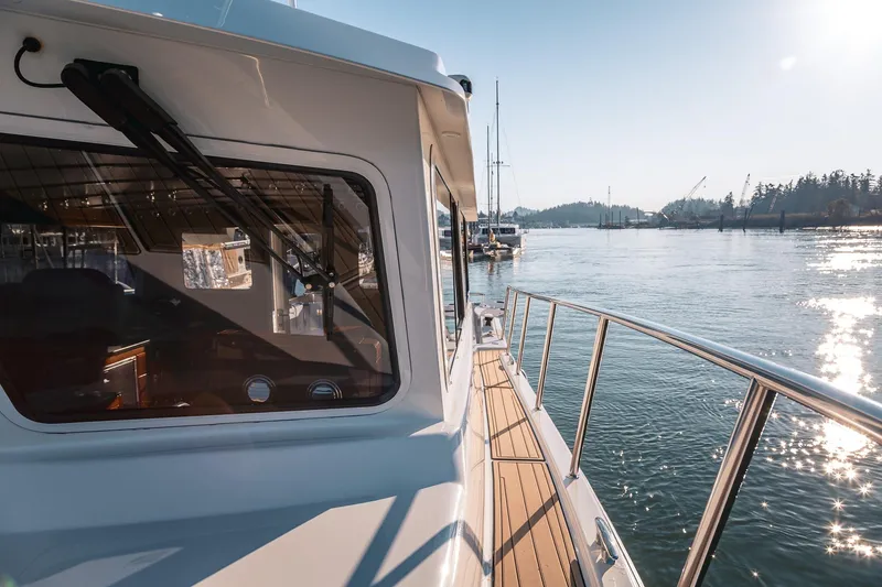 Slide: The Image of 2019 Lindell 46' yacht on serene water with sunlit reflections. - 69