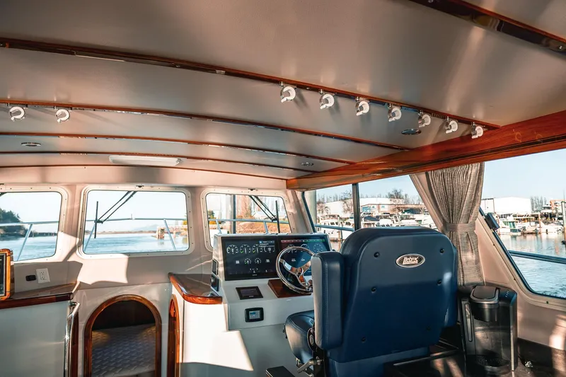 Slide: The Image of Interior of 2019 Lindell 46' yacht with helm, steering wheel, and panoramic windows. - 7