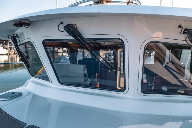 Slide: The Image of 2019 Lindell 46' yacht with sleek windows and modern design, docked at a marina. - 70