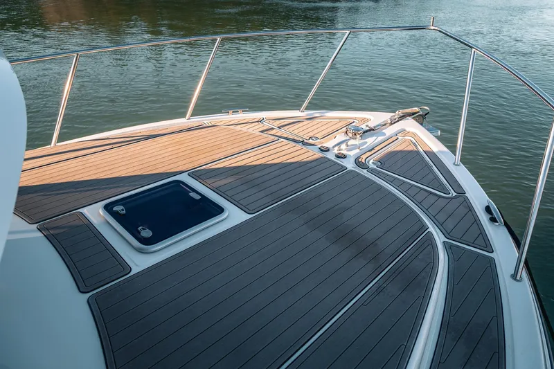 Slide: The Image of Bow of a 2019 Lindell 46' yacht with sleek teak decking on calm water. - 71