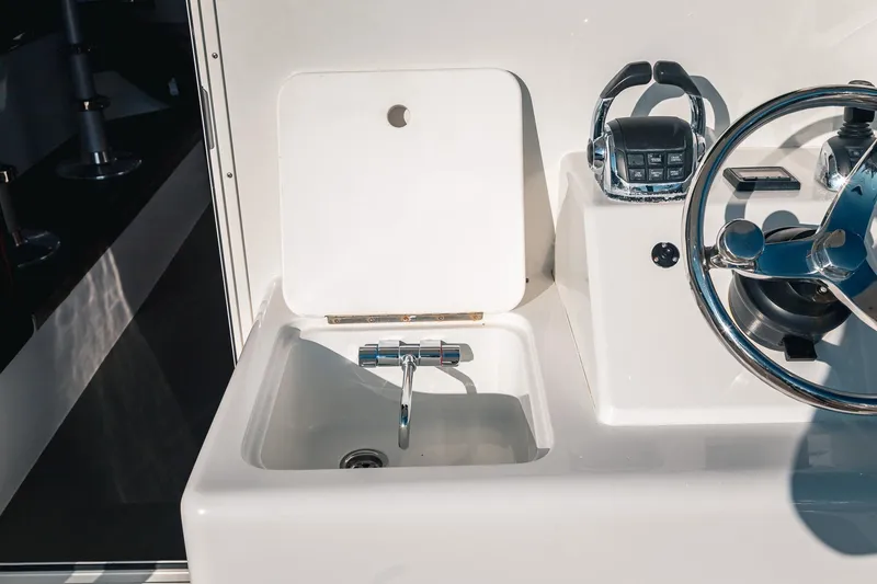 Slide: The Image of Cockpit sink and steering wheel on 2019 Lindell 46' boat. - 74