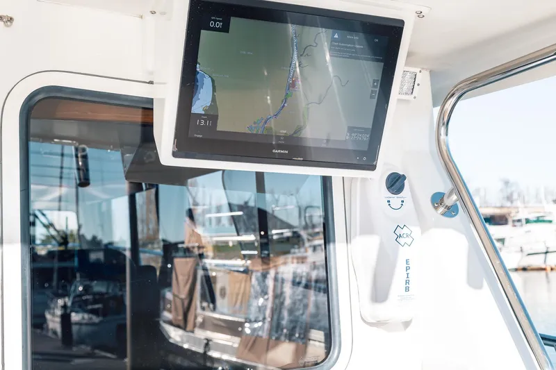 Slide: The Image of Navigation screen and EPIRB on a 2019 Lindell 46' boat, docked in a marina. - 75