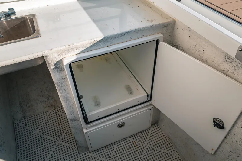 Slide: The Image of 2019 Lindell 46' boat interior with open storage compartment and sink. - 78
