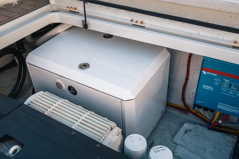 Slide: The Image of Engine compartment of a 2019 Lindell 46' boat, featuring electrical components and wiring. - 82