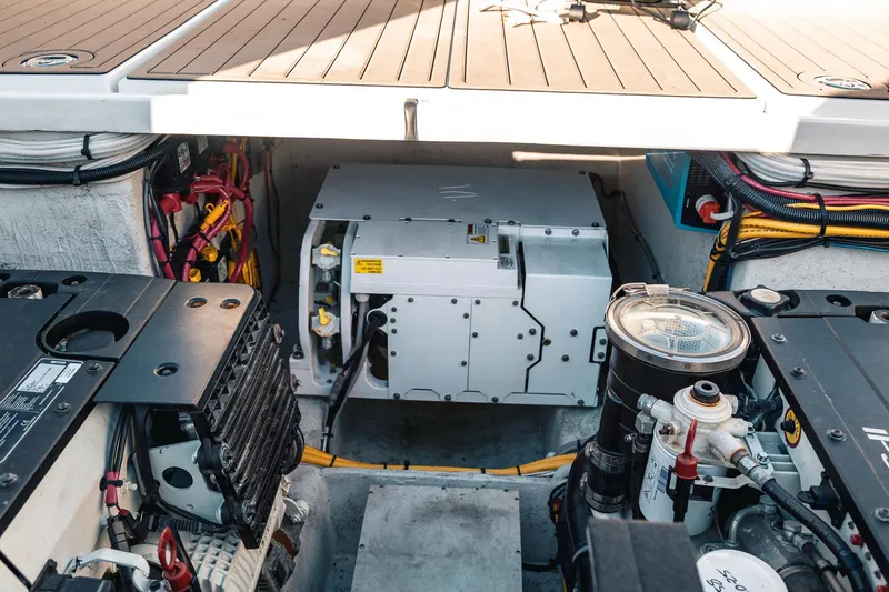 Slide: The Image of Engine compartment of a 2019 Lindell 46' boat, showcasing mechanical components and wiring. - 83