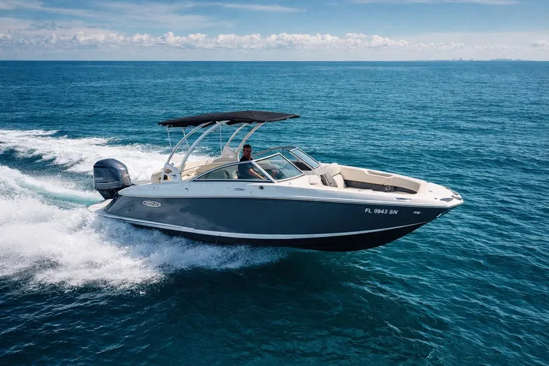 The Image of 2019 Cobalt 23SC boat cruising on open blue ocean waters. - 0