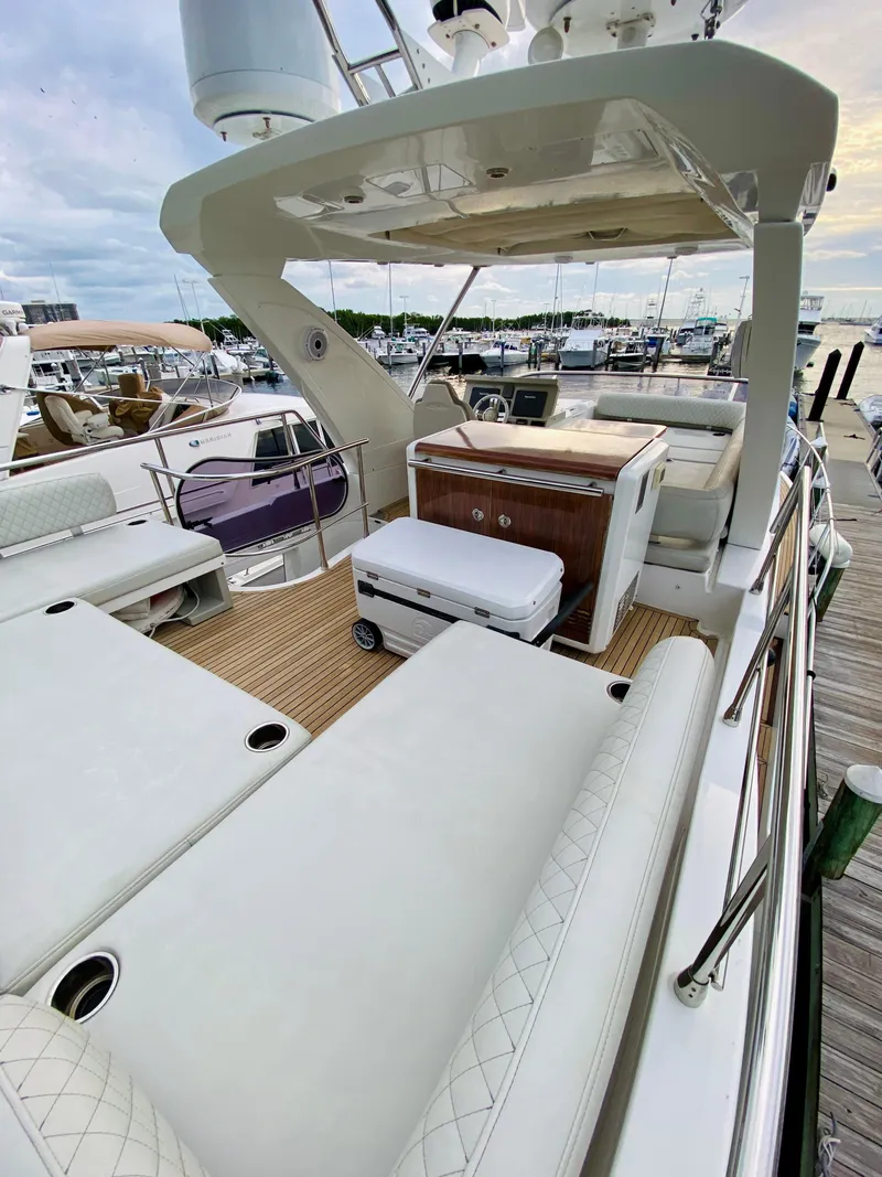Slide: The Image of 2015 Azimut 50 yacht with spacious deck and luxurious seating at marina. - 13