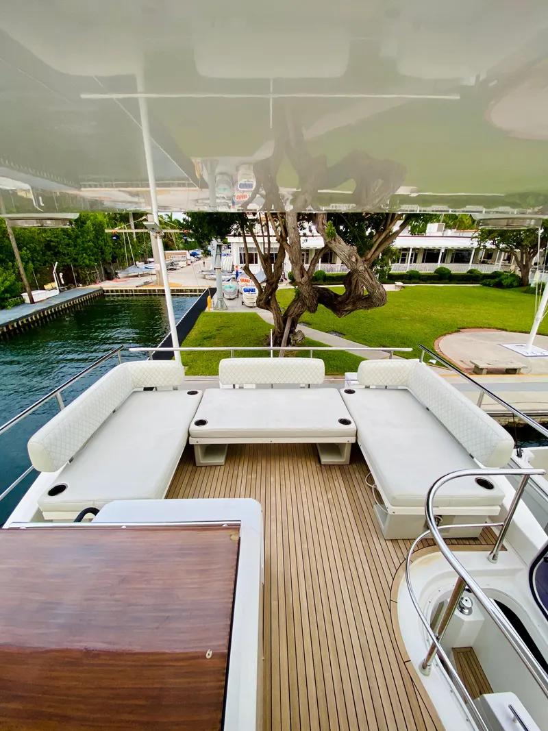Slide: The Image of 2015 Azimut 50 yacht deck with white seating and wooden flooring. - 14