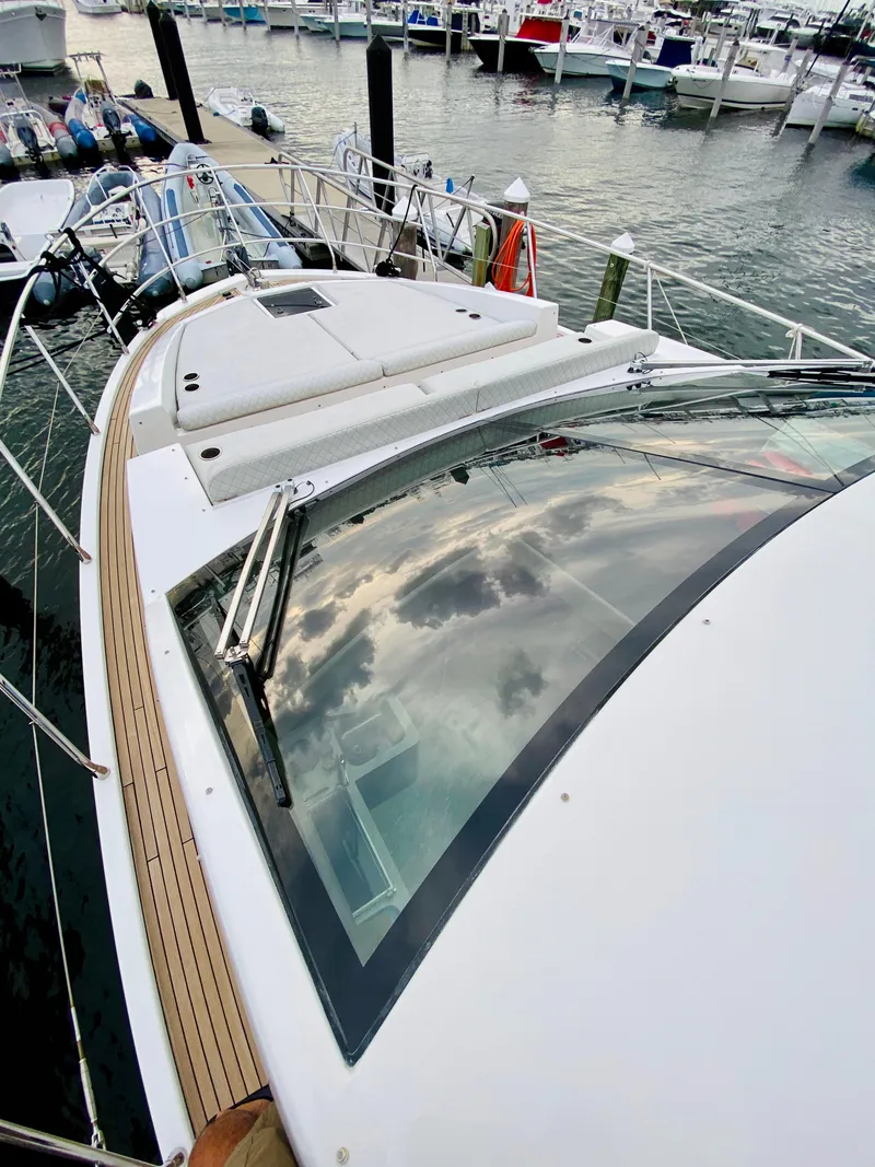 Slide: The Image of 2015 Azimut 50 yacht docked at marina, showcasing sleek design and spacious deck. - 32