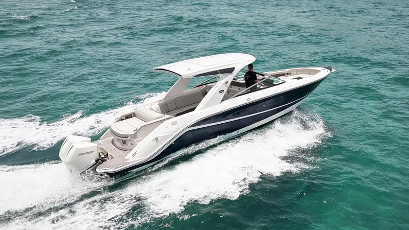Slide: The Image of 2022 Sea Ray SLX 310 Outboard cruising on open water. - 2