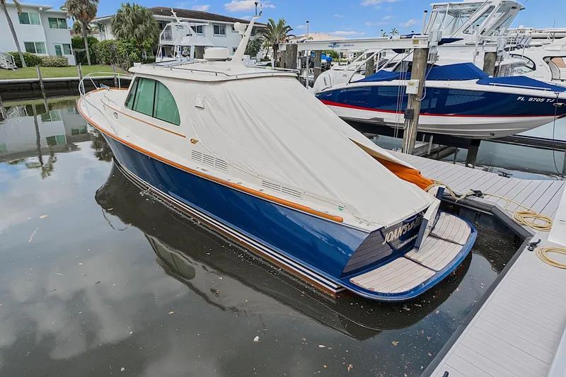 Slide: The Image of 2018 Hinckley Picnic Boat 37 MKIII docked, covered, in a marina setting. - 11