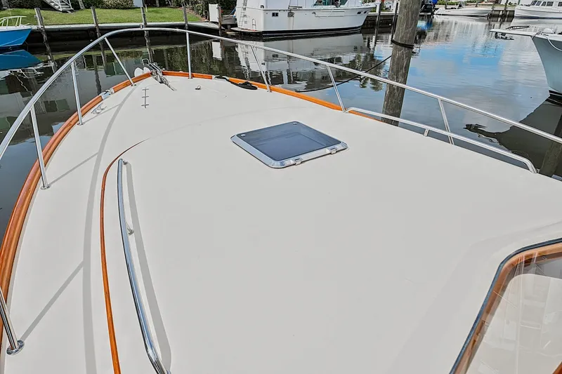 Slide: The Image of 2018 Hinckley Picnic Boat 37 MKIII bow view with sleek deck and railing. - 17