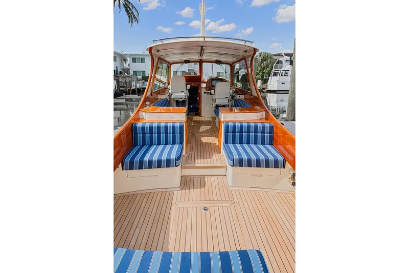 Slide: The Image of 2018 Hinckley Picnic Boat 37 MKIII with striped seating and elegant wooden deck. - 19