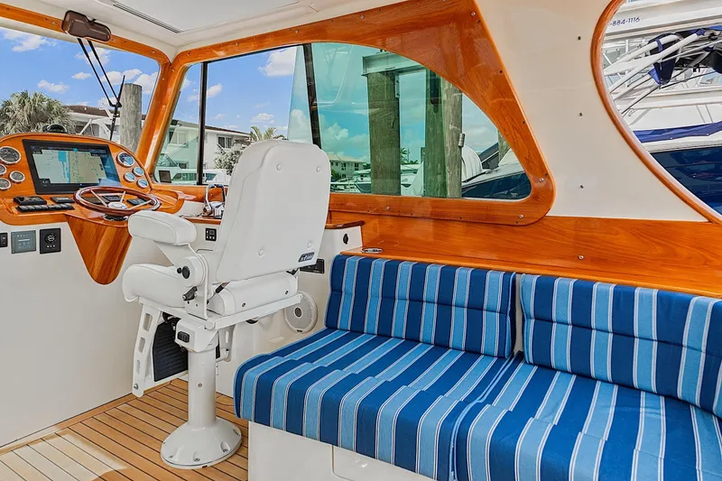 Slide: The Image of Interior of 2018 Hinckley Picnic Boat 37 MKIII with striped seating and wooden accents. - 26