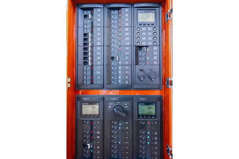 Slide: The Image of Electrical control panel of a 2018 Hinckley Picnic Boat 37 MKIII, featuring switches and displays. - 35