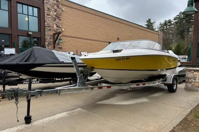 The Image of 2008 Regal 1900 Bowrider boat on trailer, yellow hull, parked outdoors. - 0