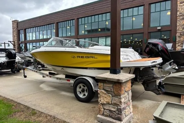 Slide: The Image of 2008 Regal 1900 Bowrider boat on trailer, parked outside a showroom. - 1