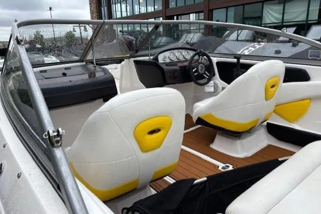 Slide: The Image of 2008 Regal 1900 Bowrider interior with white and yellow seating, dashboard, and steering wheel. - 10