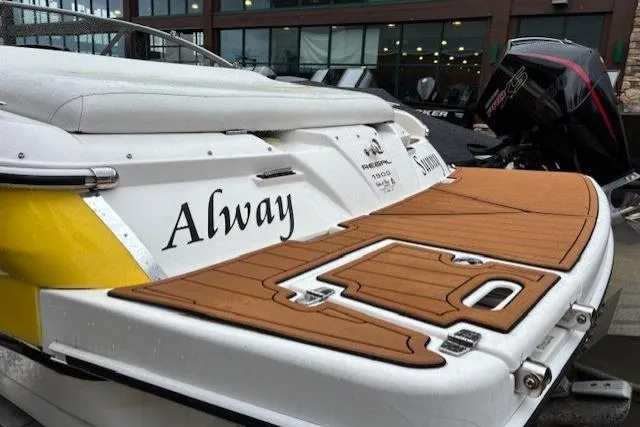 Slide: The Image of 2008 Regal 1900 Bowrider boat with teak deck, docked near a building. - 5