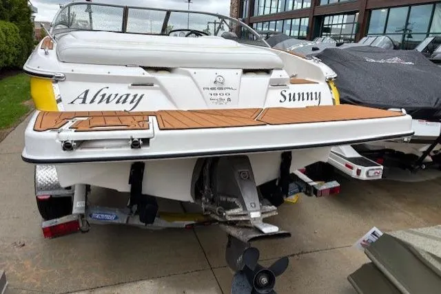 Slide: The Image of 2008 Regal 1900 Bowrider boat with teak deck, named "Alway Sunny," parked on trailer. - 6