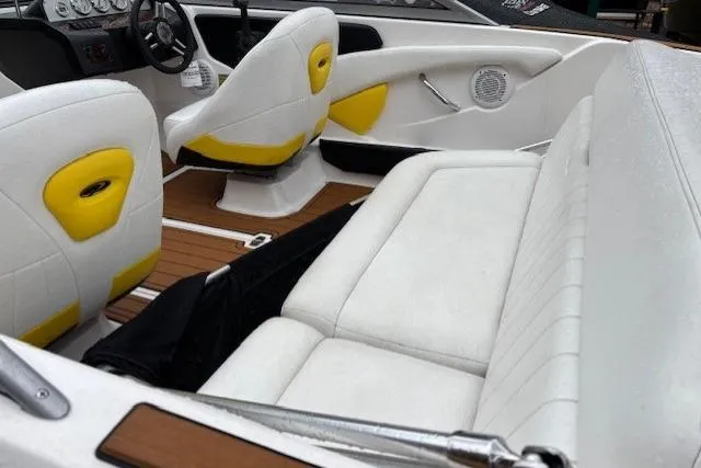 Slide: The Image of 2008 Regal 1900 Bowrider interior with white and yellow seating, wood accents, and steering wheel. - 9