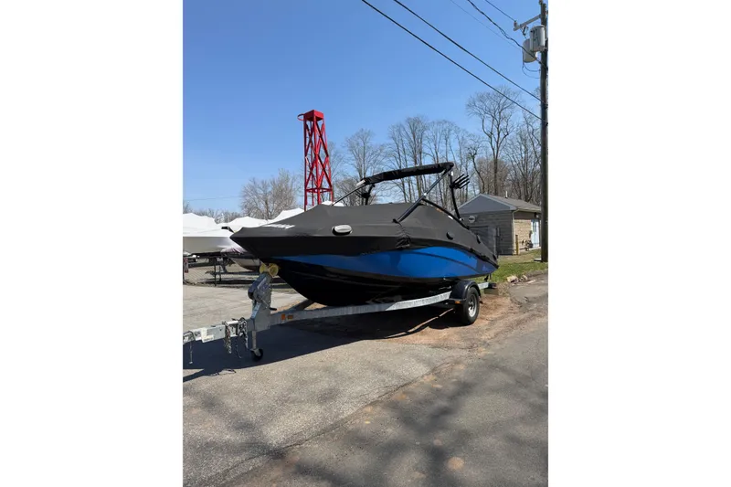 Slide: The Image of 2014 Yamaha Boats SX192 on trailer, covered, parked outdoors. - 2
